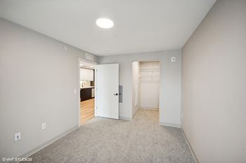 a bedroom with a closet and a door to a bathroom